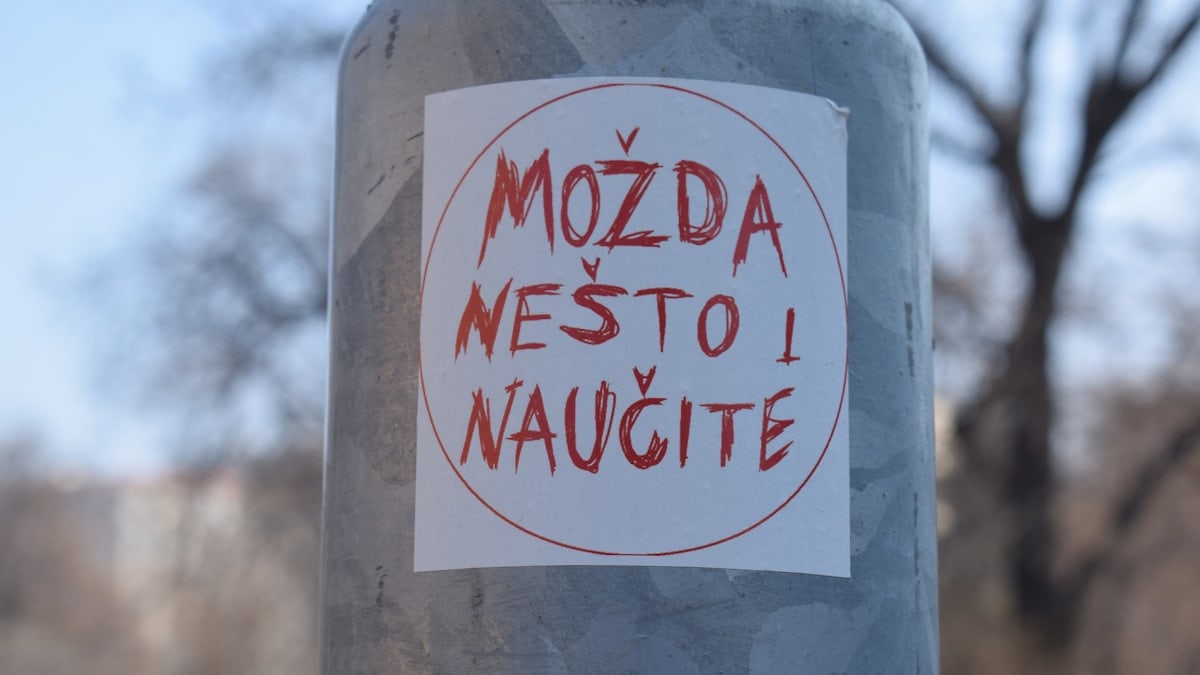 A close up of a sticker on a pole